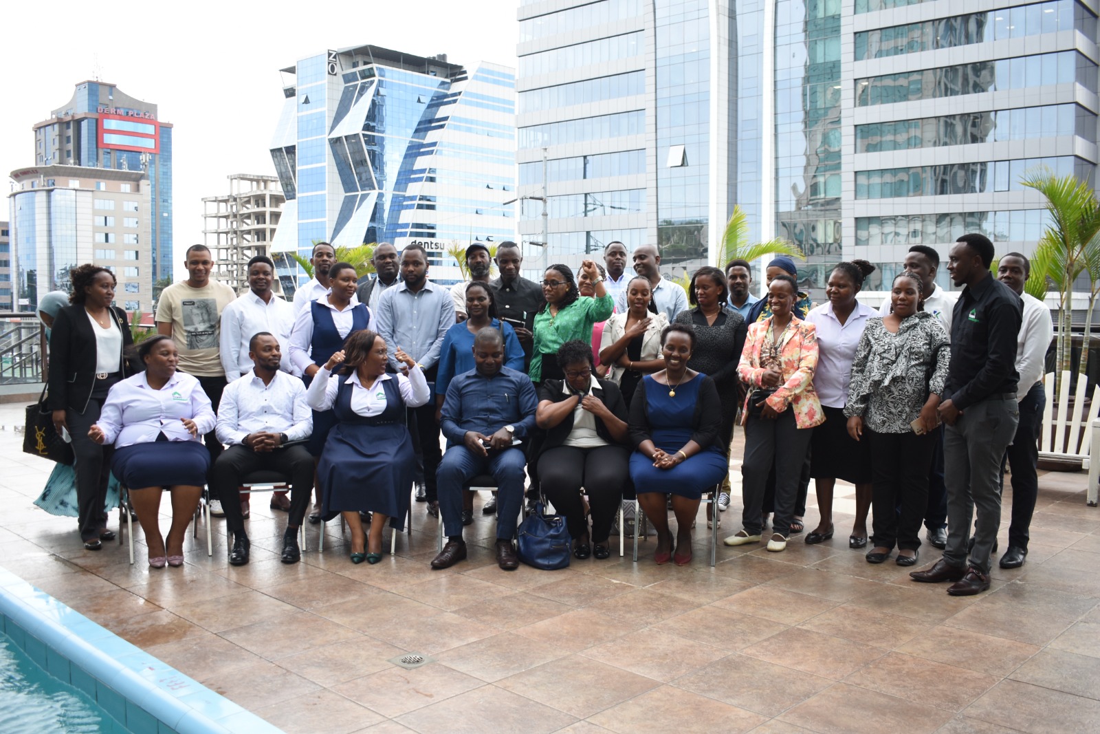 Group photo at the TAMFI advocacy meeting held on October 4, 2024, in Dar es Salaam. Seated from left to right are Judith Sando (TAMFI), Dismas Kalikawe (Endeleza Credit), Winnie Terry (TAMFI), Godfrey Ndyanabo (Stein Microfinance), Anath Ruwenza (Loan Beneficiary), and Devotha Minzi (TAMFI Board Chairperson).